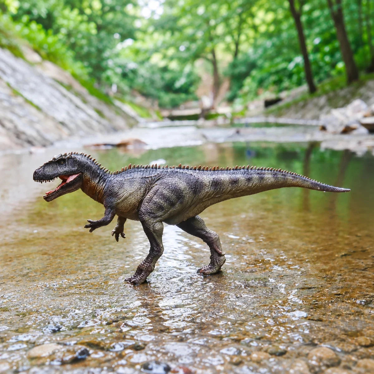 faunov Giganotosaurus T5004 figure standing in a shallow stream, full-body left-side view